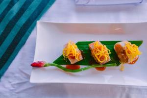 a white plate with some food on it at Sita Beach Resort in Ko Lipe