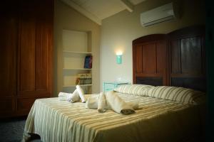 A bed or beds in a room at Corte Boero Bed&Breakfast
