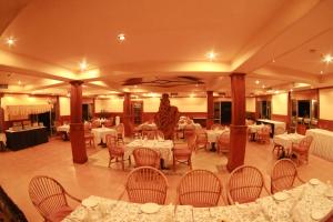 a restaurant with tables and a statue in the middle at The Oasis Beach Resort in Hambantota