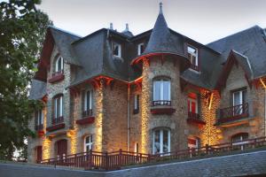 a large brick building with a large roof at Le Castel Marie Louise in La Baule
