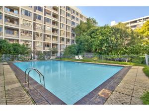 a large swimming pool in front of a building at 437 St Martini Gardens Apartments in Cape Town