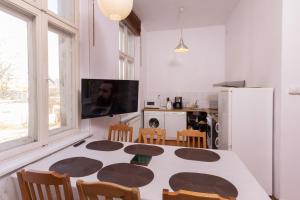 a kitchen and dining room with a table and chairs at Forum Sopot in Sopot