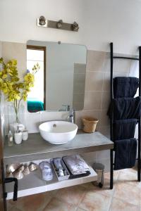 a bathroom with a sink and a mirror at Lone Star House in Sainte-Maxime