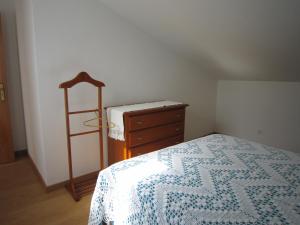 a bedroom with a bed and a dresser and a ladder at casa d'Azoia in Sesimbra +2 photos