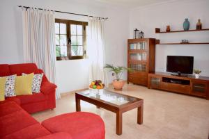 a living room with a red couch and a tv at Casa Lava in Yaiza