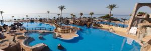 a resort with a large pool with a water slide at Holiday World Polynesia in Benalmádena