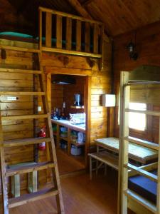 a room with two bunk beds and a desk at La Cabane du Raideur in Cilaos