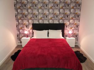 1 dormitorio con 1 cama roja y 2 mesitas de noche en Funchal Paradise en Funchal