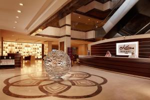 a lobby with a large silver vase on the floor at Makarem Umm Al Qura Hotel in Mecca