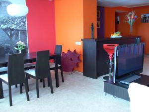 a dining room with a table and a television at 7 Days Hotel Kamyanets-Podilskyi in Kamianets-Podilskyi