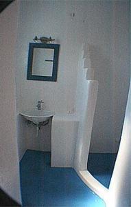 a white bathroom with a sink and a mirror at Villa Sophie in Naousa