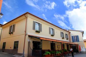 a person standing in front of a building at Albergo Benito in Norcia
