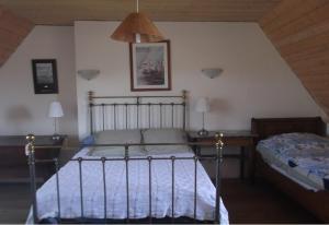 a bedroom with a bed and a lamp at Méréhenc in Plouha