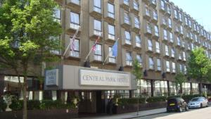 a large building with a sign on the side of it at Central Park Hotel in London