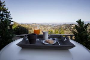 a tray of food and a glass of orange juice on a table at Residenza il Punto in Perugia +31 photos