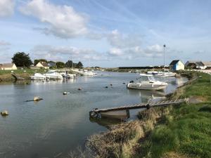a group of boats are docked in a river at Hotel de la Plage in Quinéville