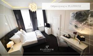 a rendering of a bedroom with a bed and a desk at Aparthotel Platinum Apartamenty in Inowrocław
