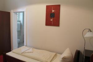 Postel nebo postele na pokoji v ubytování Hotel Pension Kima