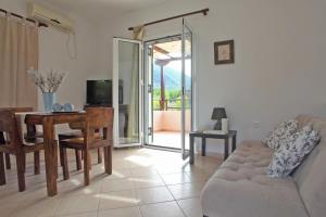 a living room with a table and a couch at Echinades Resort in Vasiliki