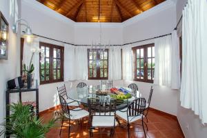 a dining room with a glass table and chairs at Villa Vistafuerte in Playa Blanca