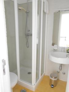 a bathroom with a shower and a toilet and a sink at Casa Abrigo do Lagar in Amares +37 photos
