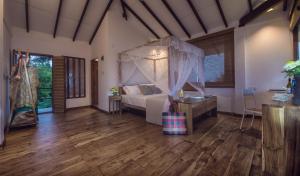 a bedroom with a bed with a canopy at C Beyond Nilaveli in Nilaveli