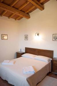 Postel nebo postele na pokoji v ubytování Il Poggio Delle Ginestre