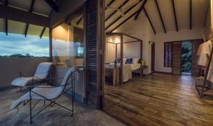 a room with a bed and a desk and a chair at C Beyond Nilaveli in Nilaveli