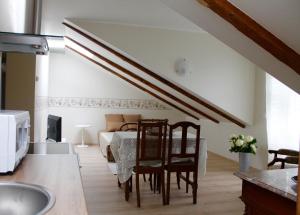 a kitchen with a table and chairs and a bedroom at Austri Villa in Pärnu