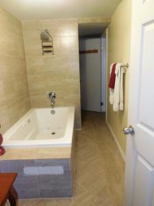 a bathroom with a bath tub in a room at Dundee Bay Villas in Freeport