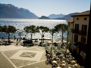 a view of a large body of water with a building at Hotel Du Lac Menaggio in Menaggio