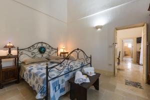 a bedroom with a bed and a table with towels at Casale Cappuccio Apartments in Ostuni +91 photos