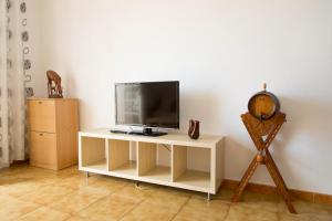 a tv sitting on a white table in a room at Las Vistas Beach in Playa de las Americas