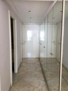 an empty hallway with glass doors and a walk in closet at Residence Palais Miramar in Cannes