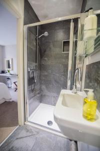 a bathroom with a shower and a sink at Chestnut Villa in Grasmere