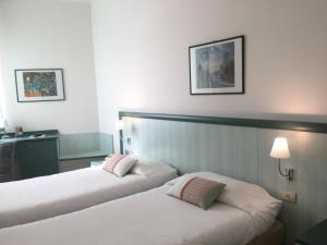 Postel nebo postele na pokoji v ubytování Hotel Europa