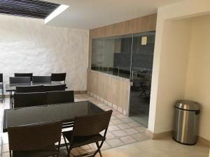 a dining room with black chairs and a table at Hotel Villa Blanca in Popayan