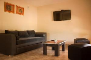 a living room with a couch and a coffee table at Cabañas La María Josefa in San Rafael