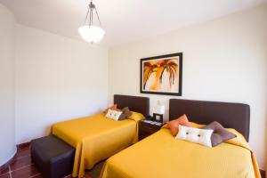 Säng eller sängar i ett rum på Hotel Posada Loma