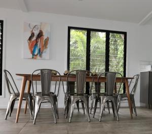 a dining room with a wooden table and chairs at Stonewood Views in Diwan