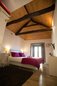 una camera da letto con un grande letto con cuscini viola di Historical Porto Studios a Porto
