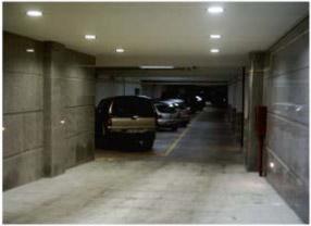 a parking garage with cars parked in it at Costa do Sol B&B in Porto