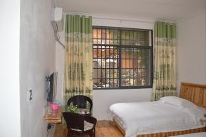 Cama o camas de una habitación en Yangjiajie Inn
