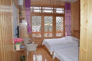 Cama o camas de una habitación en Yangjiajie Inn