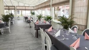 a restaurant with tables and chairs with pink napkins on them at Pałac Łagów - Hotel in Zgorzelec