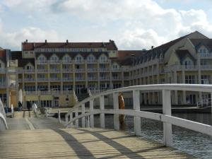 a bridge over the water in front of a large building at Ferienhaus Schoen in Rheinsberg