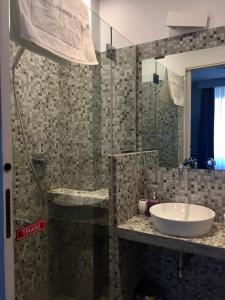 a bathroom with a sink and a shower at Royal Suite du Vatican in Rome