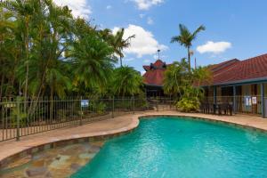 a beach with a pool and a house at Beenleigh Yatala Motor Inn in Yatala