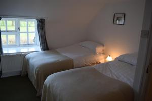 Tempat tidur dalam kamar di Ceiros Cottage