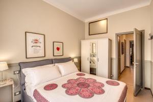 a bedroom with a large bed with red flowers on it at Cinque Terre The Harbour Apt - Two bathrooms in La Spezia